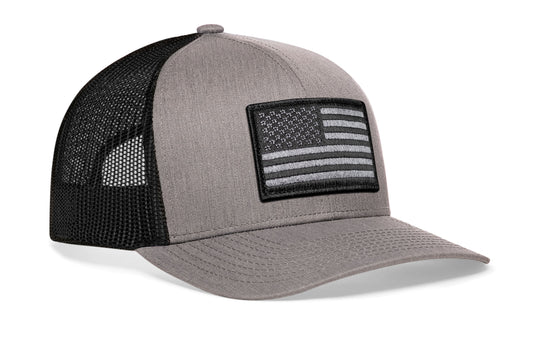 Gray/Black trucker hat viewed from the right side, showcasing a American Flag Embroidered Rectangle Patch prominently displayed on the front