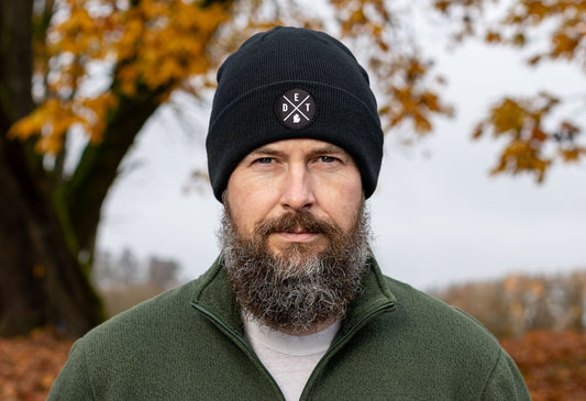 Black beanie worn by a male model featuring a Detroit DET X Woven Circle Patch.