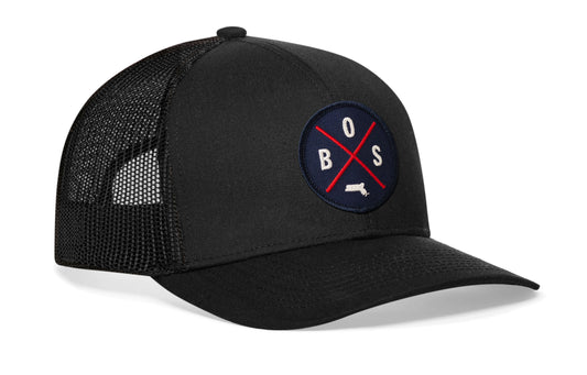 Black trucker hat viewed from the right side, showcasing a Boston BOS X Red & Navy Embroidered Circle Patch prominently displayed on the front