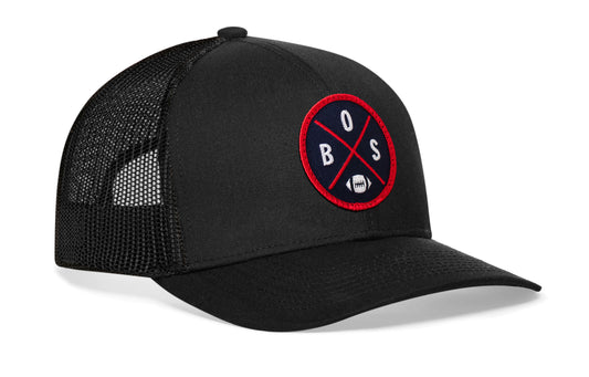 black trucker hat viewed from the right side, showcasing a BOS Football embroidered X patch in blue and red prominently displayed on the front