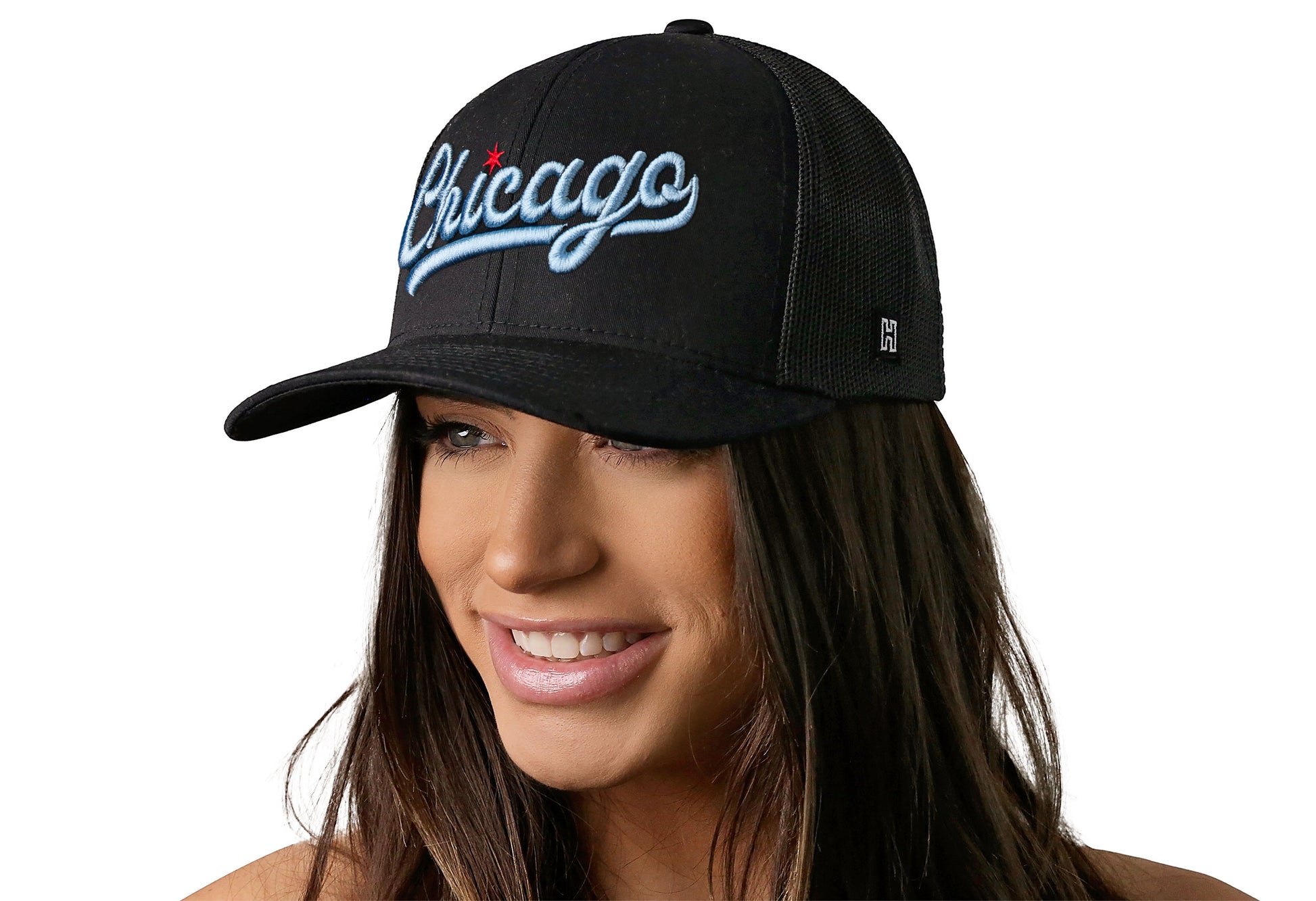 black trucker hat worn by a female model viewed from the left side and features a "Chicago" Script with Red Star 3D Embroidery displayed on the front panel. The hat has a classic mesh back design and a curved structured bill.