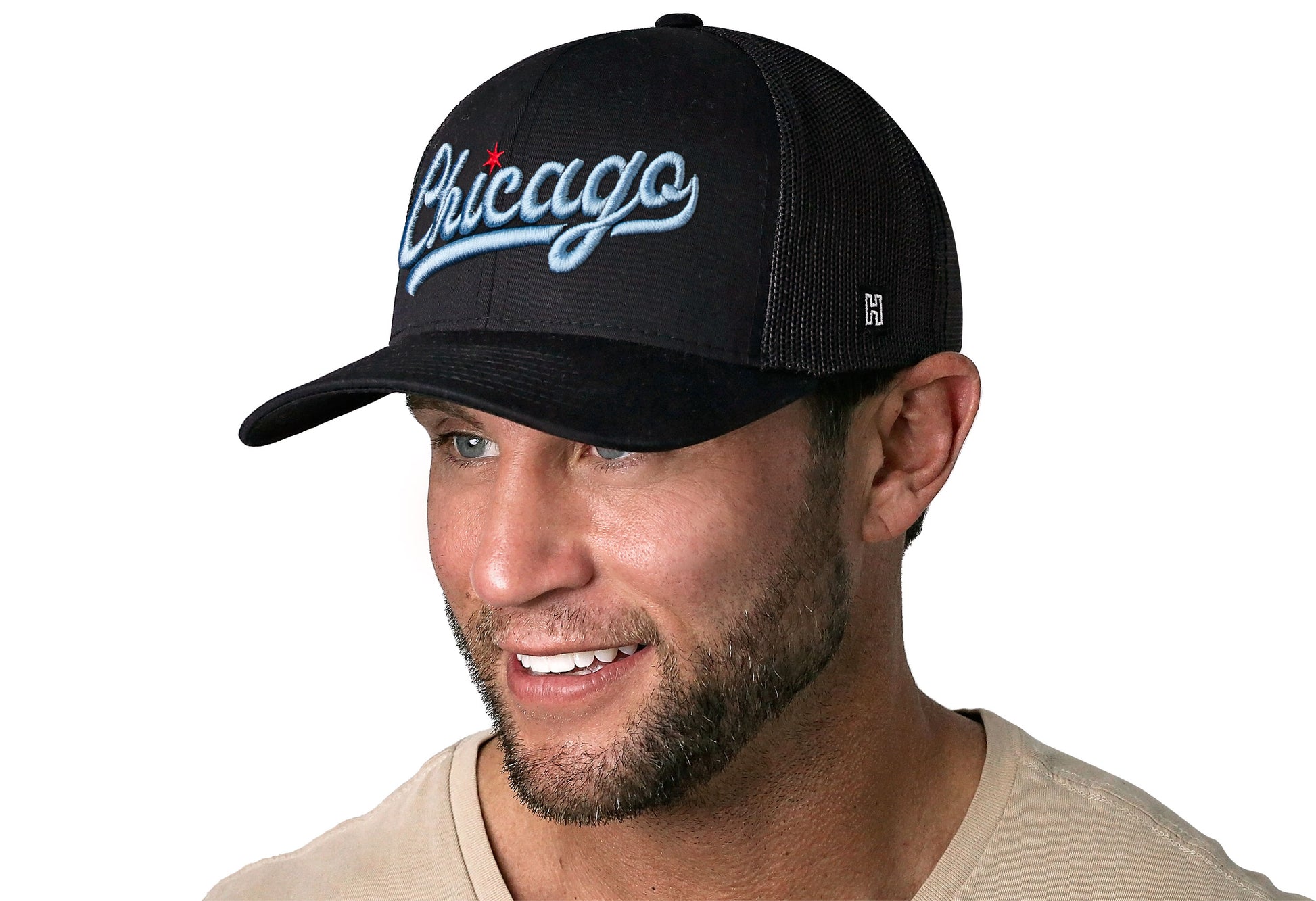 black trucker hat worn by a male model viewed from the left side and features a "Chicago" Script with Red Star 3D Embroidery displayed on the front panel. The hat has a classic mesh back design and a curved structured bill.