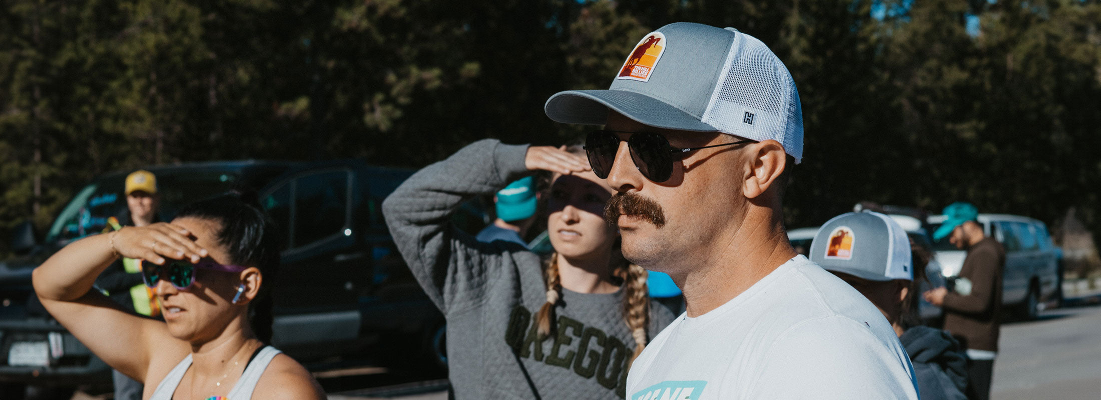 Custom Haka Hat design on gray white trucker on sleek dark background, showcasing personalized team relay style and comfort-fit adjustable sweatband for all sexes.