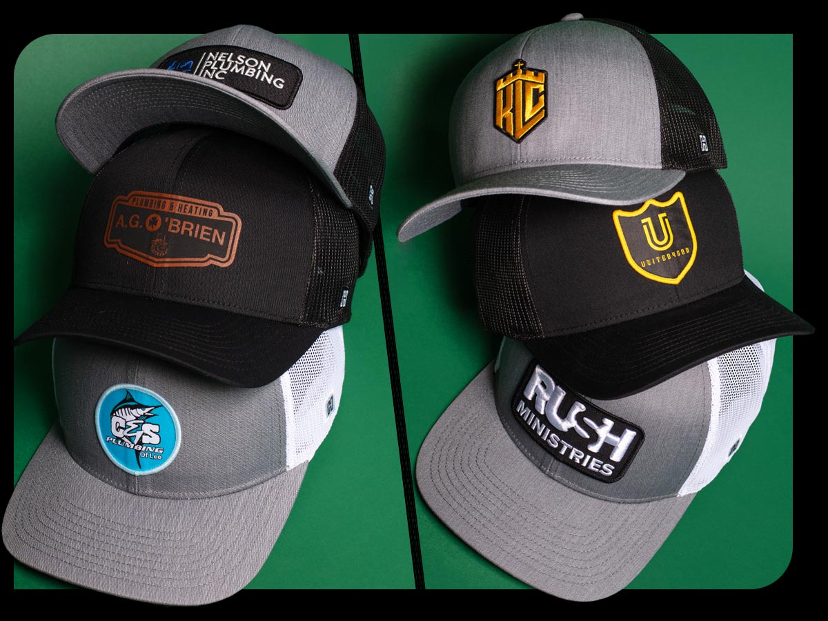 Stack of Haka Custom Trucker Hats featuring caps for Church, Ministry, Business, Trades and Schools on green background