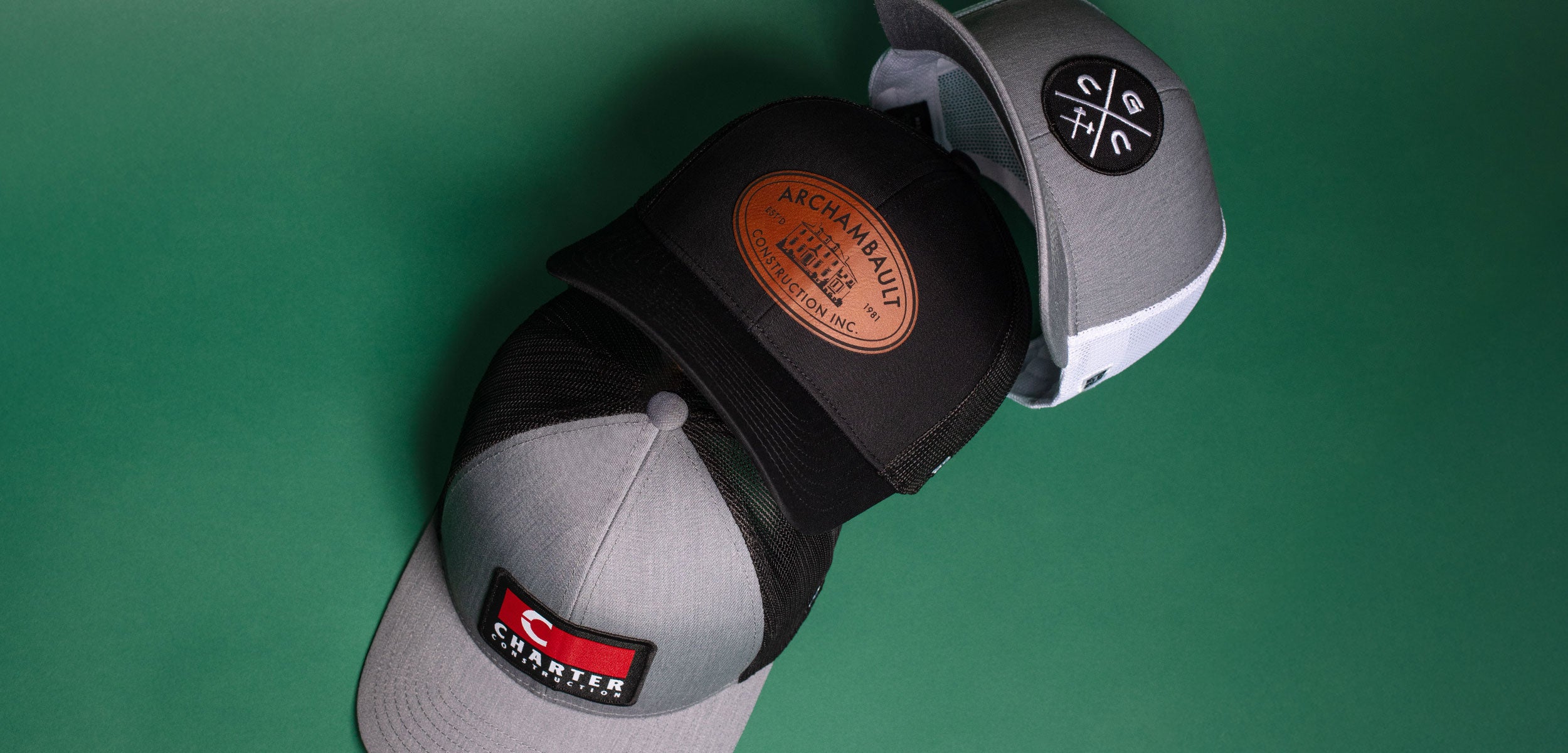 Gray cap with brand logos on a green background