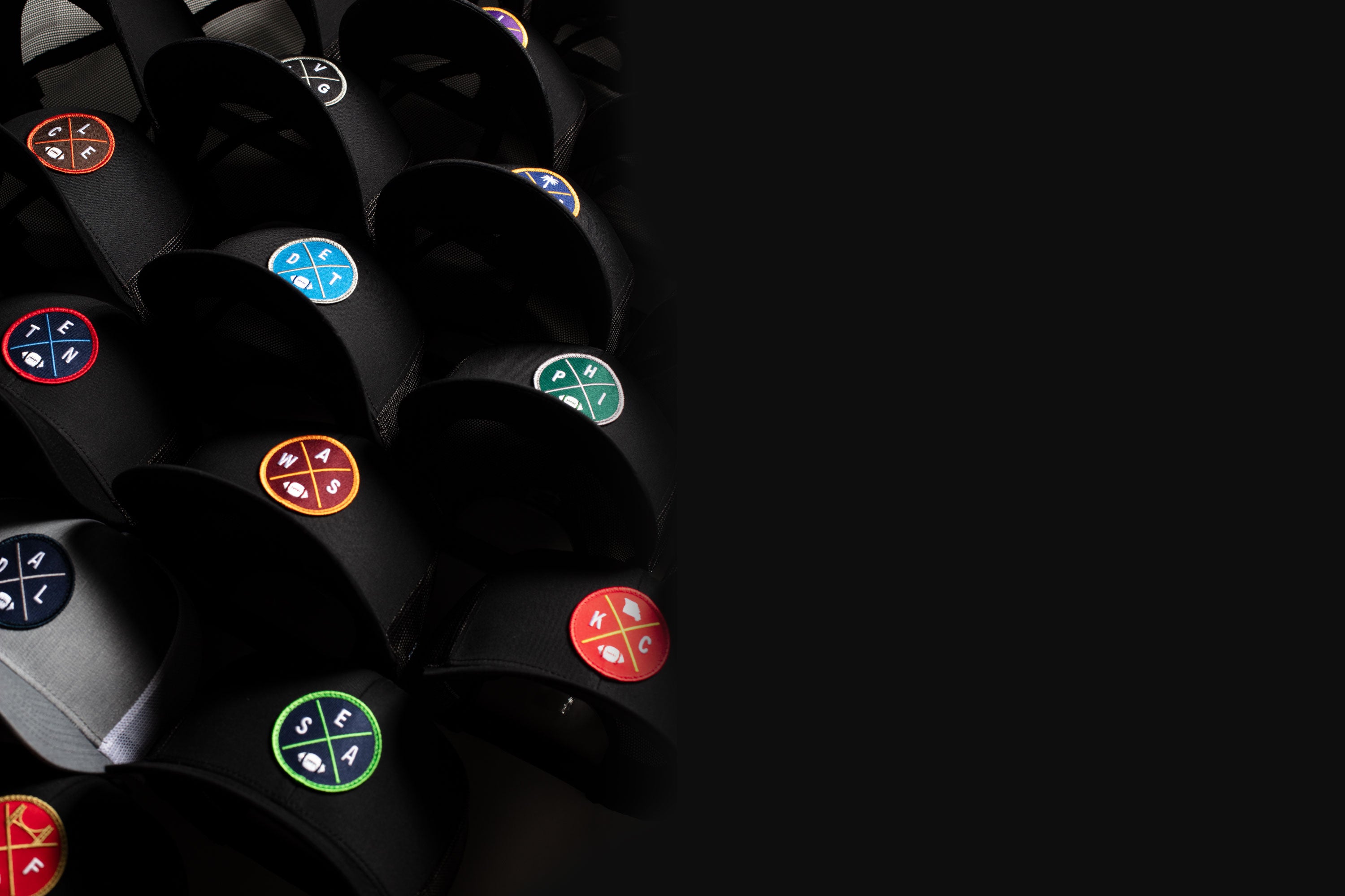 Black trucker hats with colorful city football designs on a black background