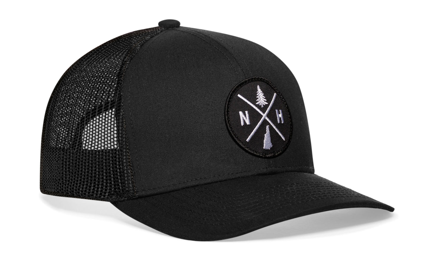 Black trucker hat viewed from the right side, showcasing a New Hampshire NH X Embroidered Circle Patch prominently displayed on the front