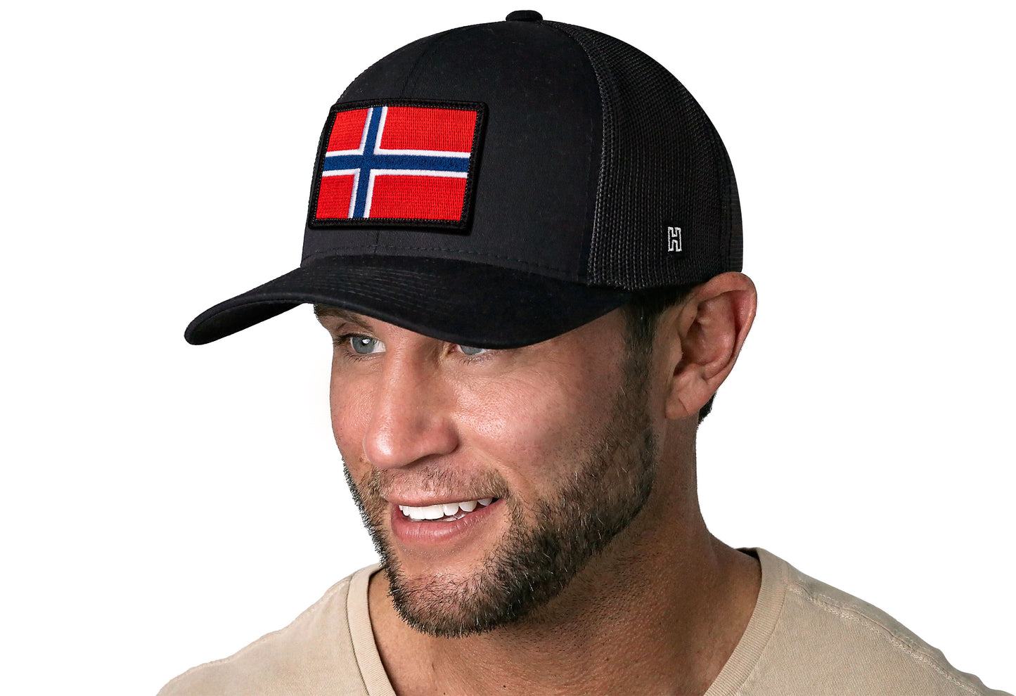 Black trucker hat worn by a male model viewed from the left side and features a Norwegian Flag Embroidered Rectangle Patch displayed on the front panel. The hat has a classic mesh back design and a curved structured bill