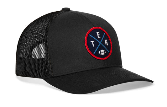 black trucker hat viewed from the right side, showcasing a TEN Football embroidered X patch in navy, blue, and red prominently displayed on the front