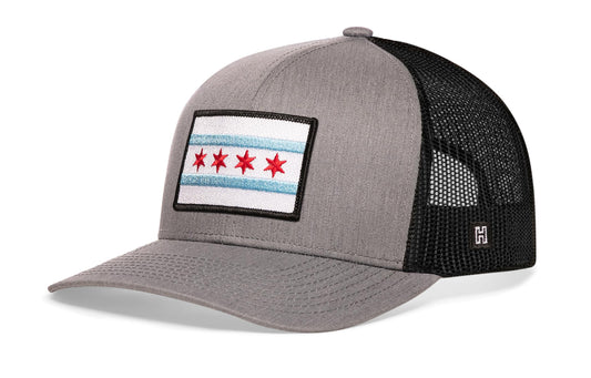 Chicago Trucker Hat, gray-black snapback showing Haka brandmark on left side of cap.