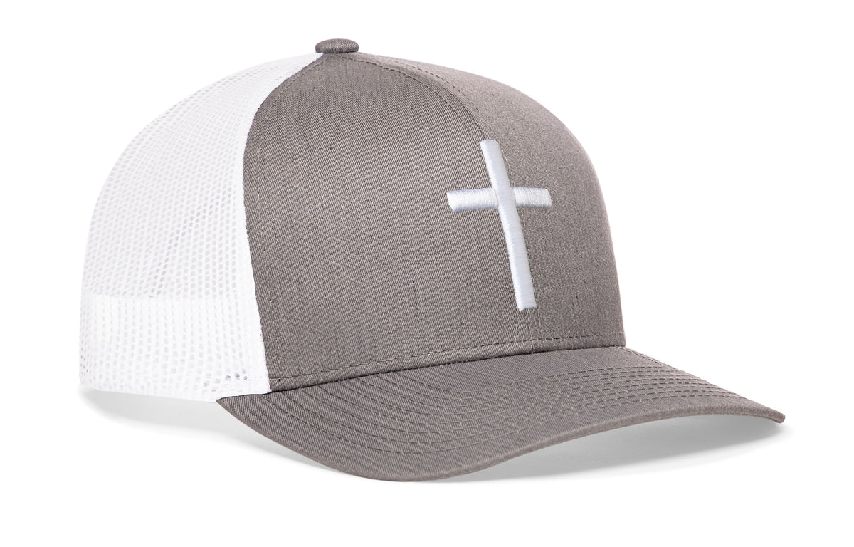 gray-white trucker hat viewed from the right side, showcasing a bold cross bold white 3D embroidery prominently displayed on the front