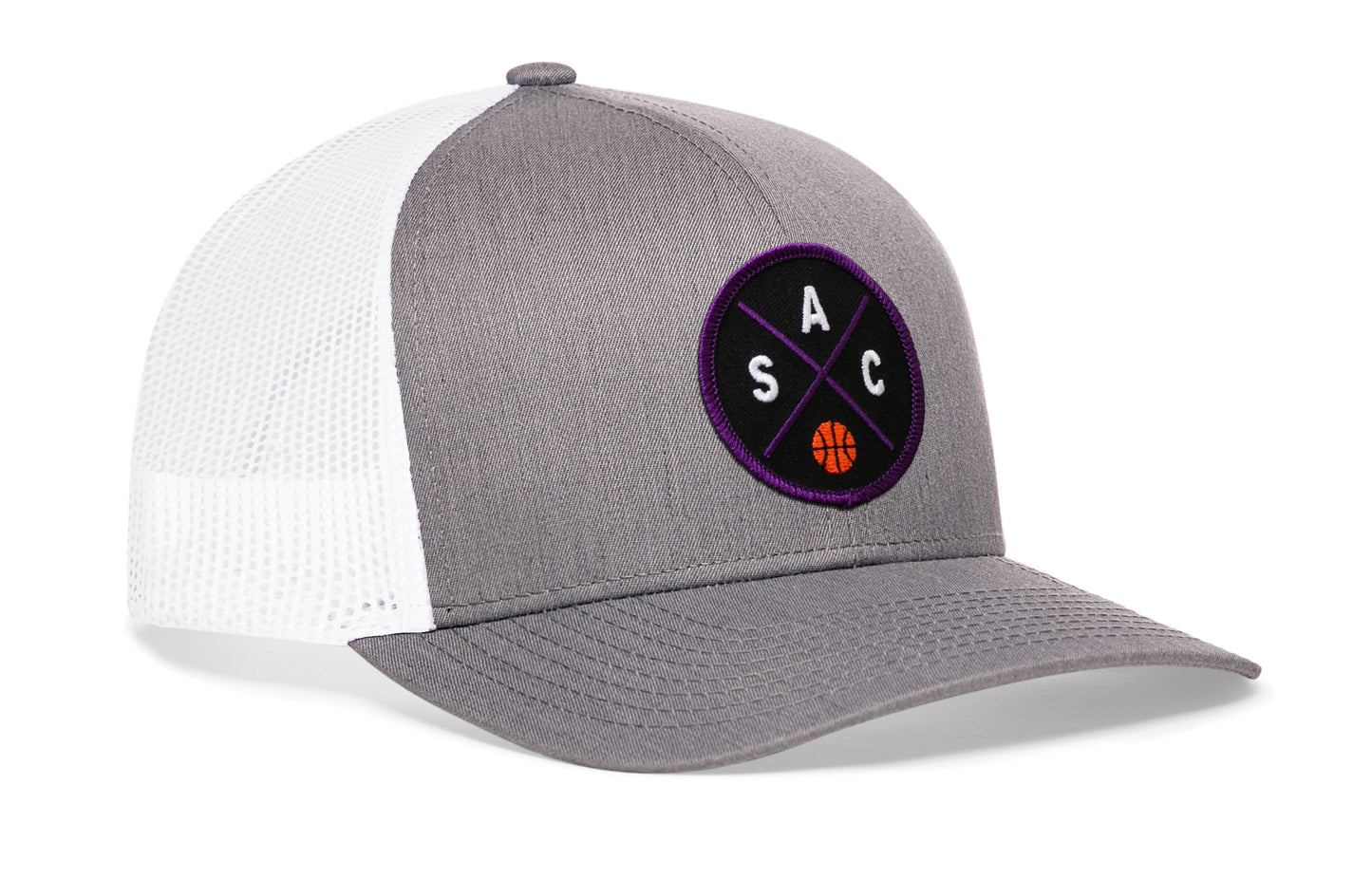 gray-white trucker hat viewed from the right side, showcasing a purple and black basketball embroidered X patch prominently displayed on the front