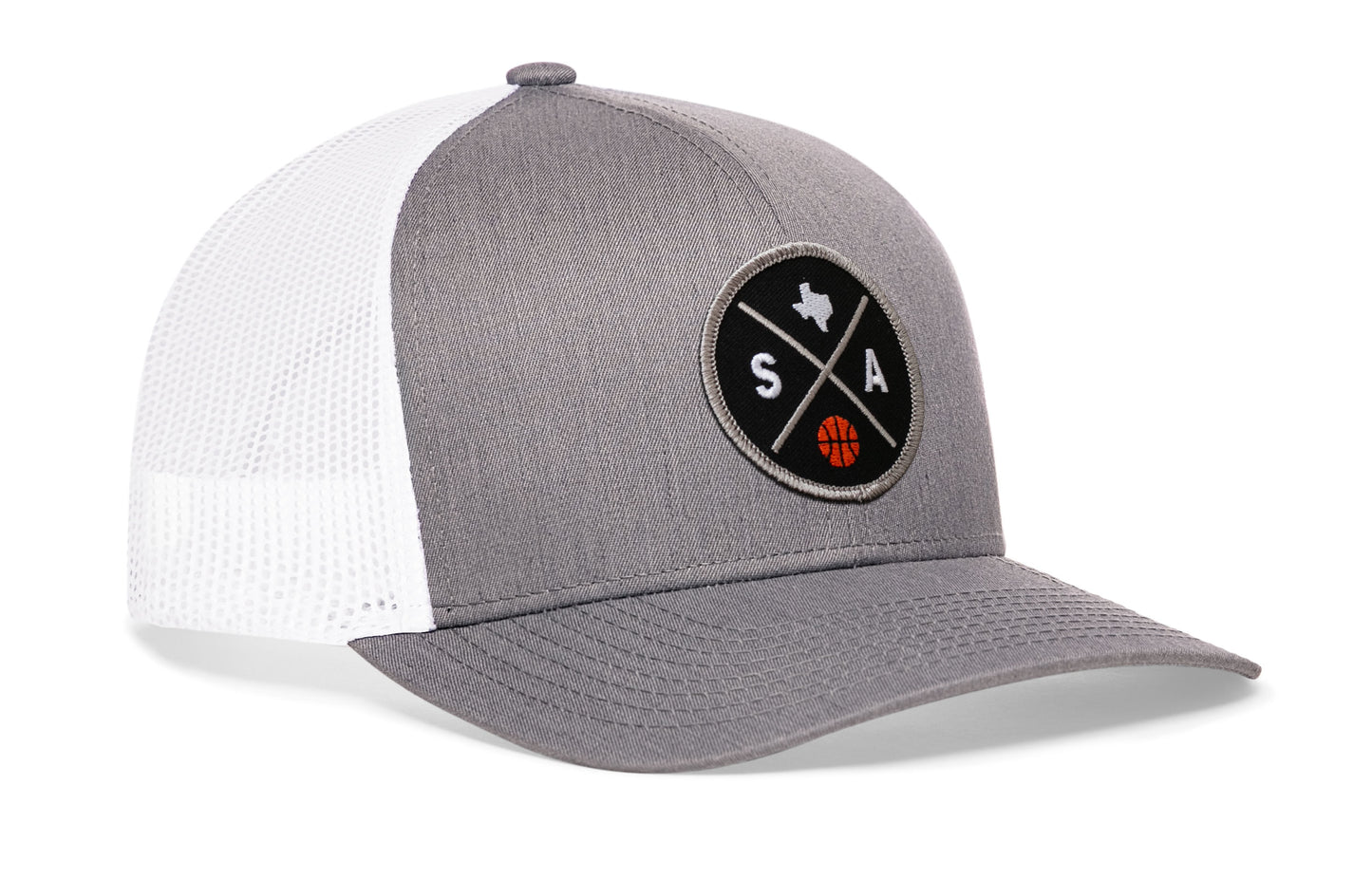 gray-white trucker hat viewed from the right side, showcasing a bold black and gray embroidered X patch prominently displayed on the front