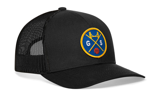 black trucker hat viewed from the right side, showcasing a navy and gold basketball embroidered X patch prominently displayed on the front