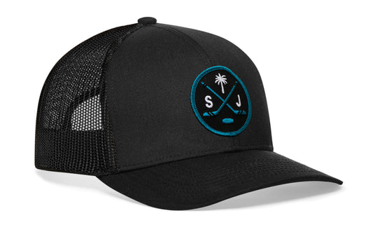 black trucker hat viewed from the right side, showcasing a black and teal hockey embroidered X patch prominently displayed on the front