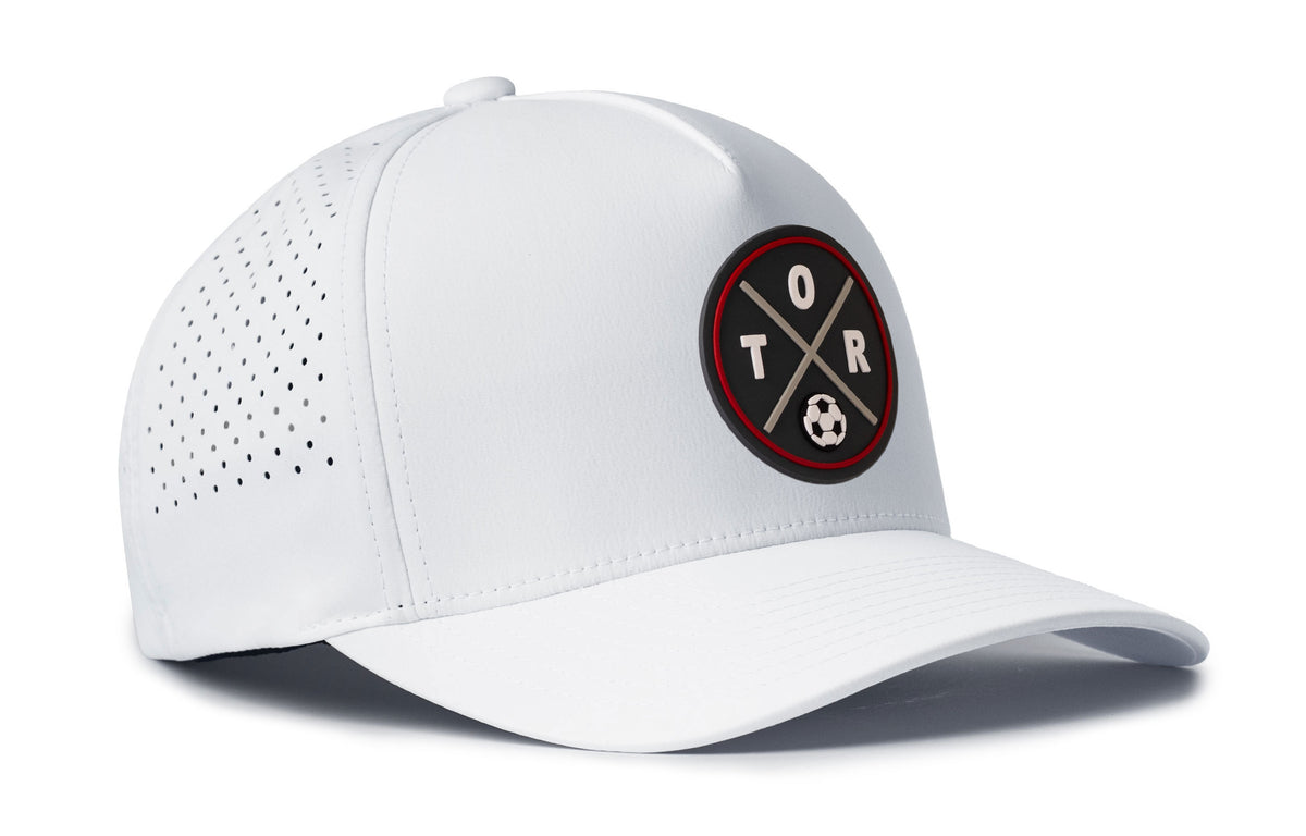 white performance 5-panel hat viewed from the right side, showcasing a bold red and black pvc patch prominently displayed on the front