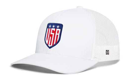 USA Shield Trucker Hat, white snapback showing Haka brandmark on left side of cap.