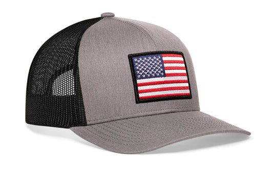 Gray/Black trucker hat viewed from the right side, showcasing a American Flag Embroidered Rectangle Patch prominently displayed on the front