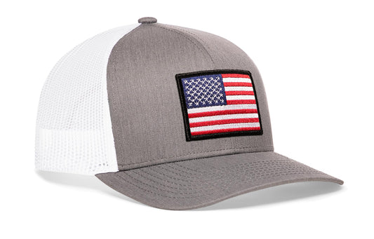 Gray/White trucker hat viewed from the right side, showcasing a American Flag Embroidered Rectangle Patch prominently displayed on the front