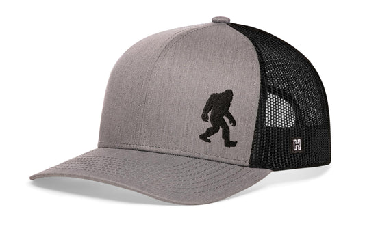 Haka Bigfoot Trucker Hat, Gray-Black snapback for wilderness explorers. Fans of Big Foot and other cryptoid.