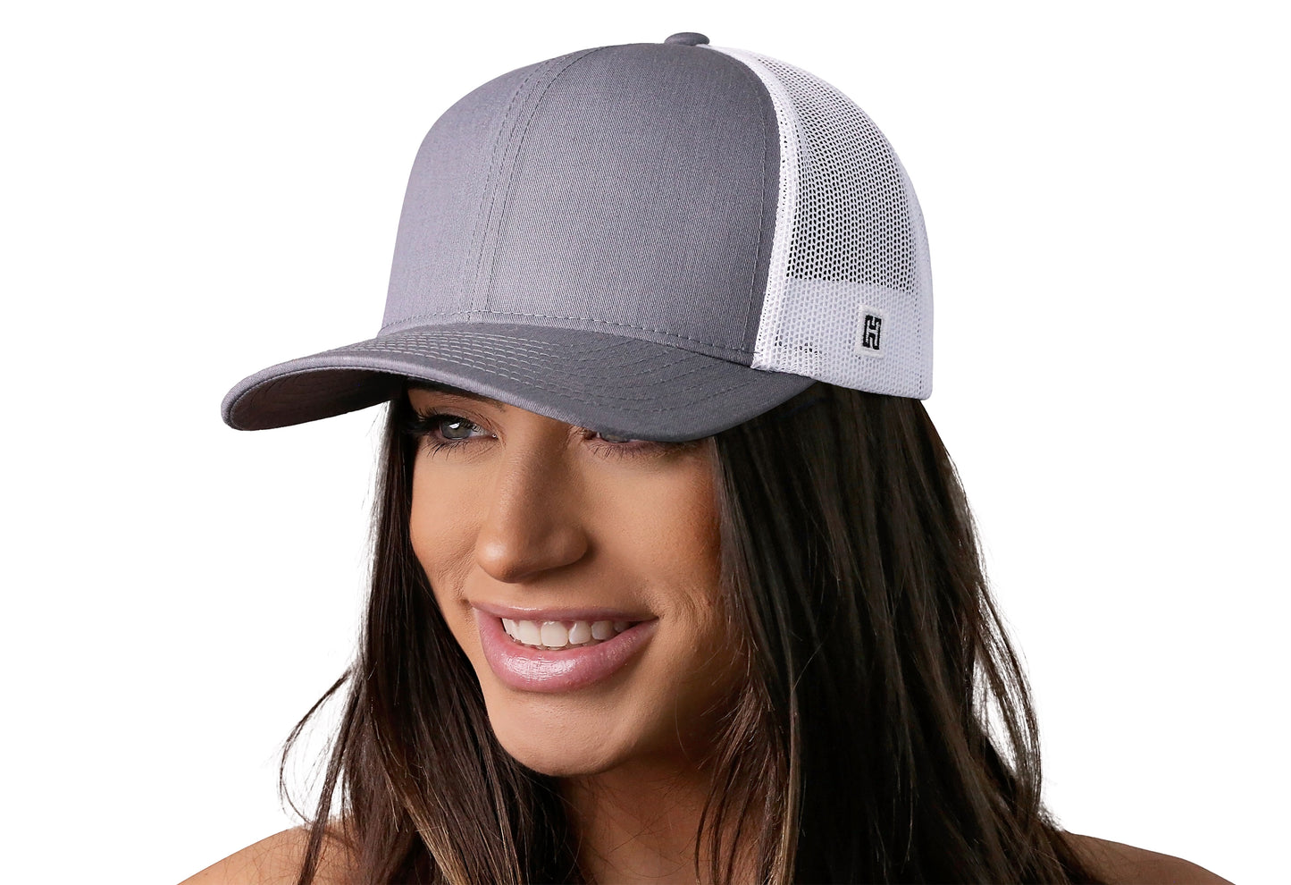 Gray-White trucker hat worn by a female model viewed from the left side and features a n/a, Blank Gray White Hat displayed on the front panel. The hat has a classic mesh back design and a curved structured bill