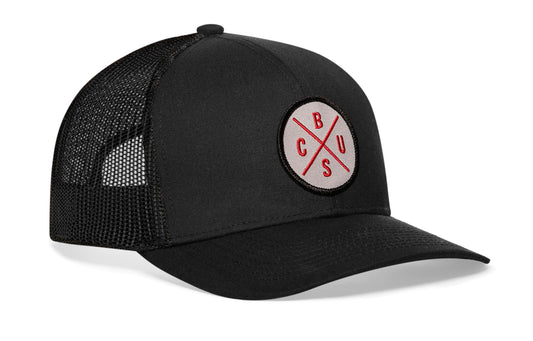 Black trucker hat viewed from the right side, showcasing a Columbus CBUS X Gray, Red Embroidered Circle Patch prominently displayed on the front