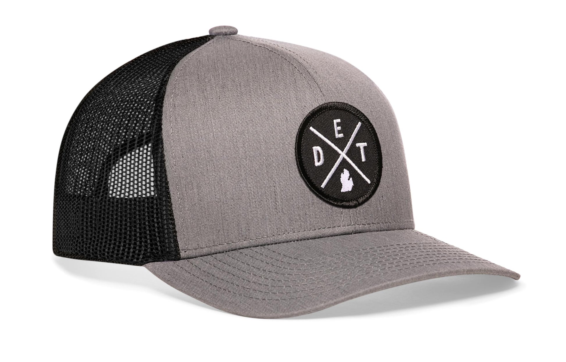 Gray-Black trucker hat viewed from the right side, showcasing a Detroit DET X Embroidered Circle Patch prominently displayed on the front