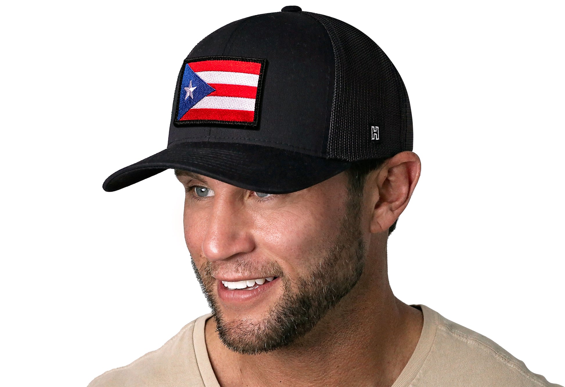 Black trucker hat worn by a male model viewed from the left side and features a Puerto Rico Flag Embroidered Flag Patch displayed on the front panel. The hat has a classic mesh back design and a curved structured bill