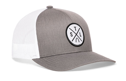 Gray-White trucker hat viewed from the right side, showcasing a St Louis STL X Embroidered White Circle Patch prominently displayed on the front
