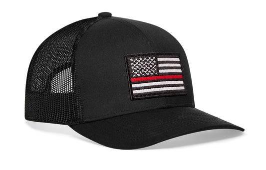 black trucker hat viewed from the right side, showcasing a bold red and white embroidered patch prominently displayed on the front