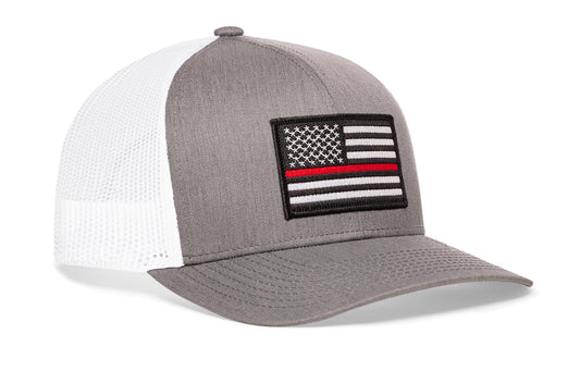 gray-white trucker hat viewed from the right side, showcasing a bold red and white embroidered patch prominently displayed on the front