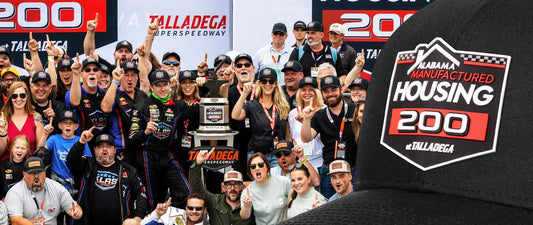 Andy Jankowiak in the winner's circle at Talladega Superspeedway after winning the Alabama Manufactured Housing 200 wearing a Haka hat