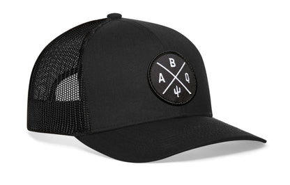 Black trucker hat viewed from the right side, showcasing a Albuquerque ABQ X Embroidered Black Circle Patch prominently displayed on the front