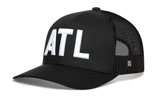 Atlanta White Block Trucker Hat, black snapback showing Haka brandmark on left side mesh.
Rep your city.