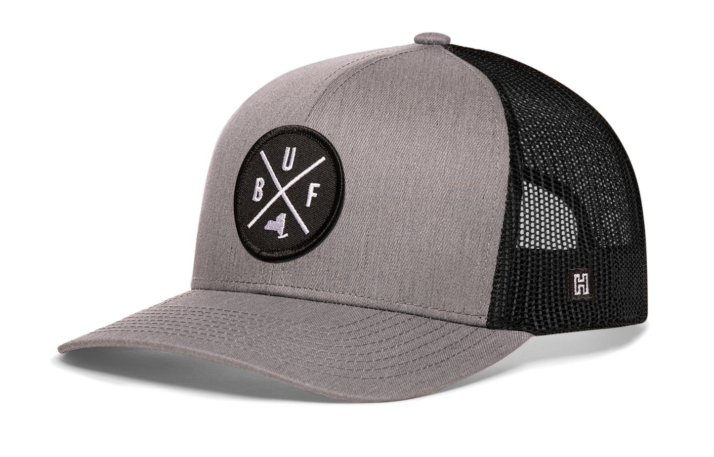 Buffalo Trucker Hat, gray-black snapback showing Haka brandmark on left side mesh.
Rep Buffalo, NY.