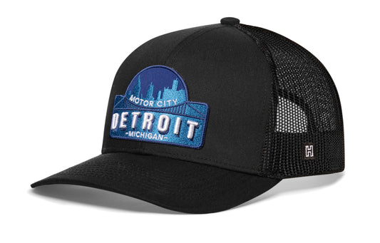 Detroit Motor City Trucker Hat, black snapback showing Haka brandmark on left side mesh.
Rep Detroit, MI.