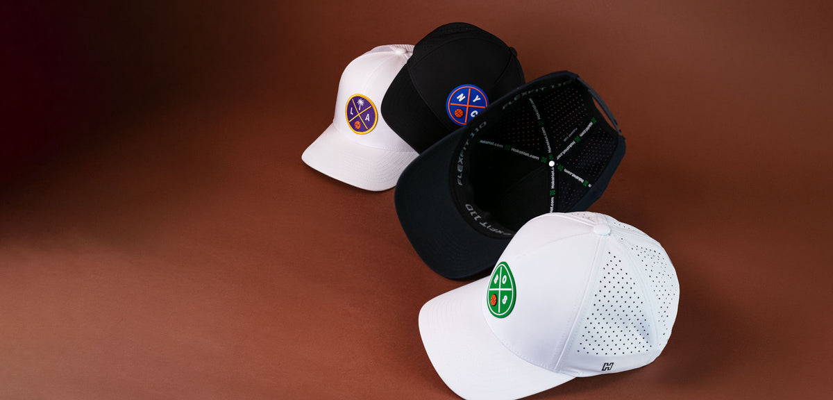collection of four basketball hats ranging from trucker to performance and featuring NYC, LA and Boston