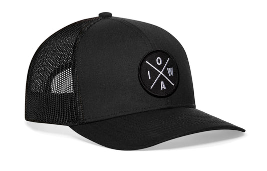 Black trucker hat viewed from the right side, showcasing a IOWA X Embroidered Circle Patch prominently displayed on the front