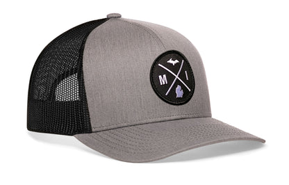 Gray-Black trucker hat viewed from the right side, showcasing a Michigan MI X Embroidered Circle Patch prominently displayed on the front