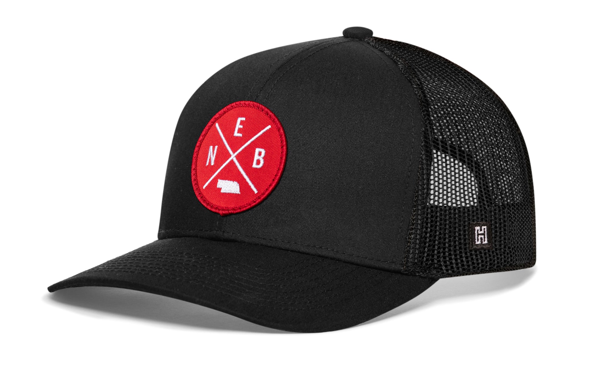 Haka Nebraska trucker hat, black snapback, viewed from the left side. Represent Nebraska football.