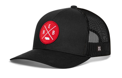 Haka Nebraska trucker hat, black snapback, viewed from the left side. Represent Nebraska football.