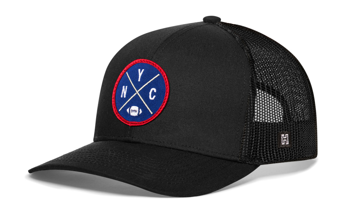 New York Football Trucker Hat, black snapback showing Haka brandmark on left side of cap.