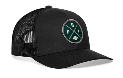 black trucker hat viewed from the right side, showcasing a PHI Football embroidered X patch in midnight green, and silver prominently displayed on the front