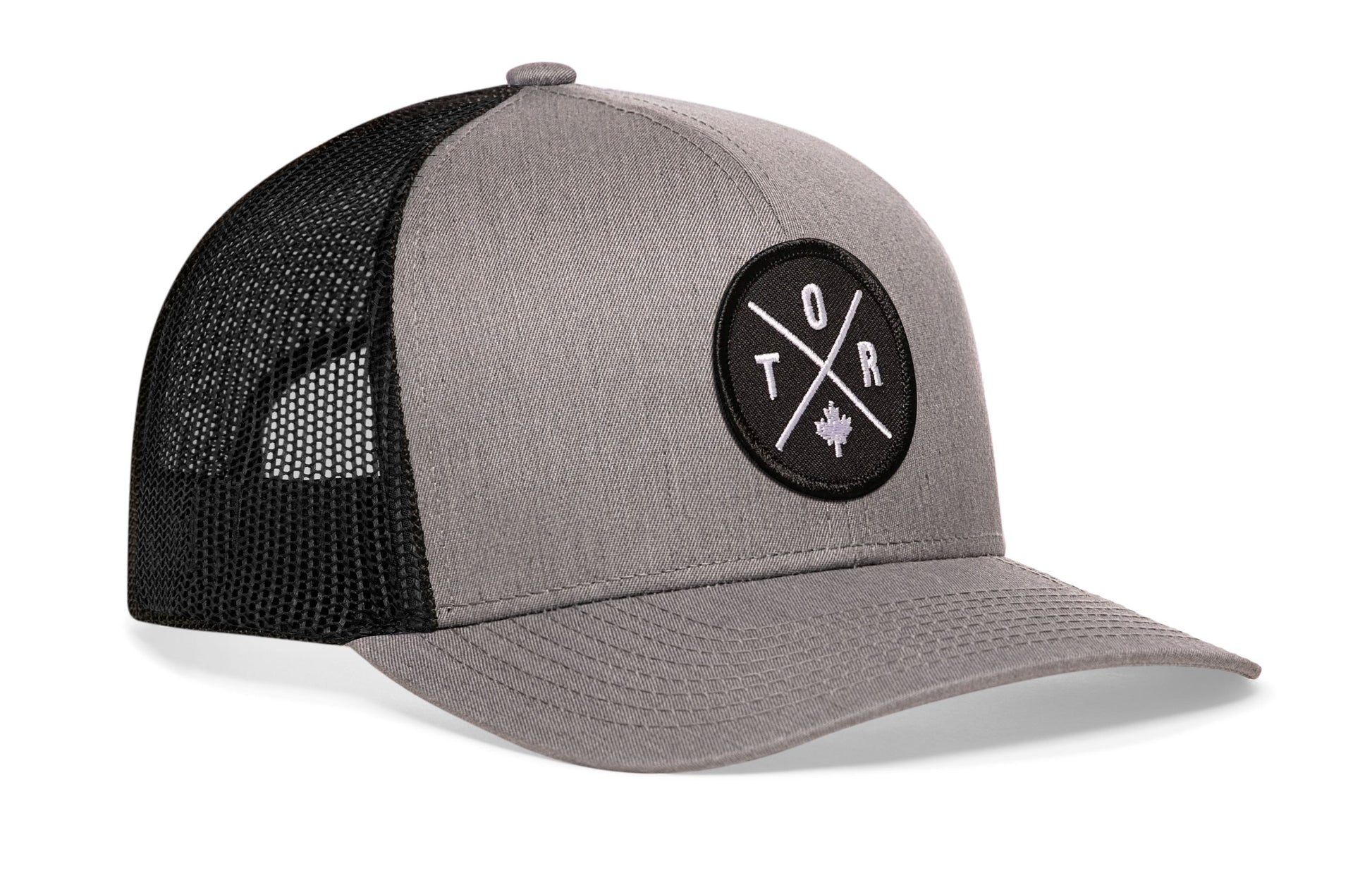 Gray-Black trucker hat viewed from the right side, showcasing a Toronto TOR X Embroidered Circle Patch prominently displayed on the front