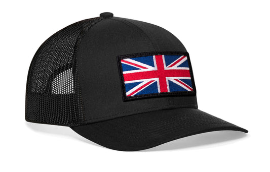 Black trucker hat viewed from the right side, showcasing a United Kingdom Flag Embroidered Rectangle Patch prominently displayed on the front