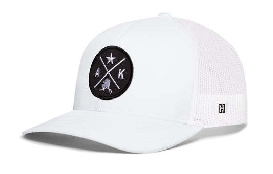 Alaska Trucker Hat, white snapback showing Haka brandmark on left side of cap.