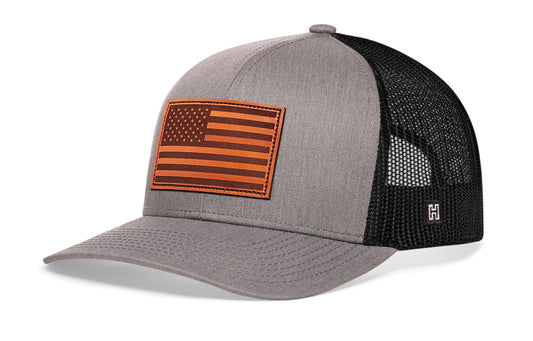 American Flag Trucker Hat Leather, gray-black snapback showing Haka brandmark on left side of cap.