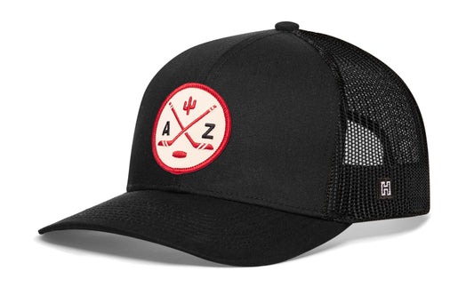 Arizona Hockey Trucker Hat, black snapback showing Haka brandmark on left side of cap.
