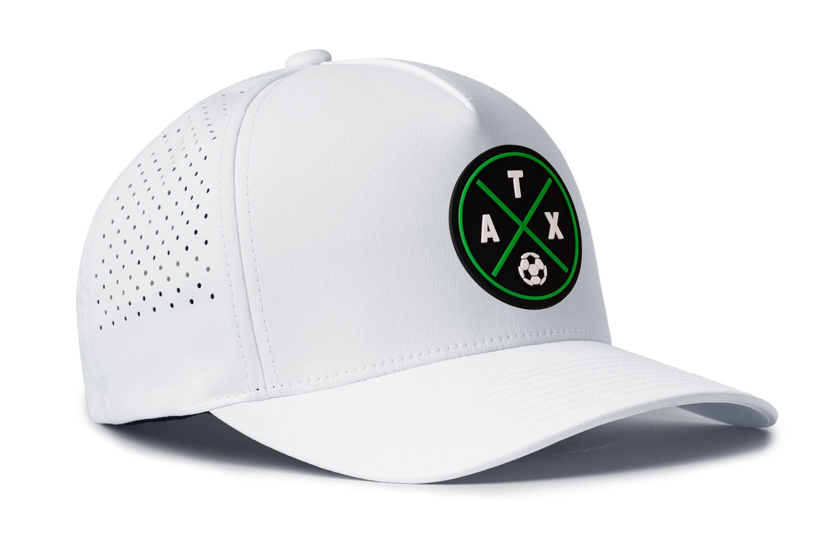 white performance 5-panel hat viewed from the right side, showcasing a bold black and green pvc patch prominently displayed on the front