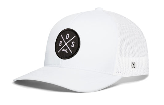 Boston Trucker Hat, gray-black snapback showing Haka brandmark on left side of cap.